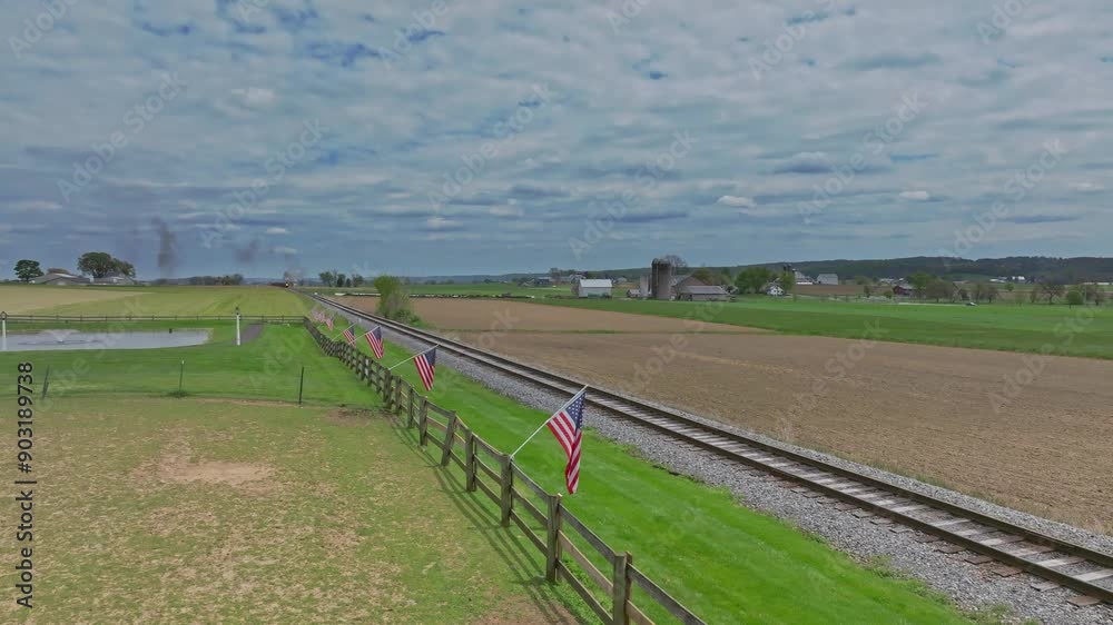 A peaceful view of the Pennsylvania countryside, featuring a railroad track lined with American flags. High quality 4k footage A peaceful view of the Pennsylvania countryside, featuring a railroad track lined with American flags. High quality 4k footage