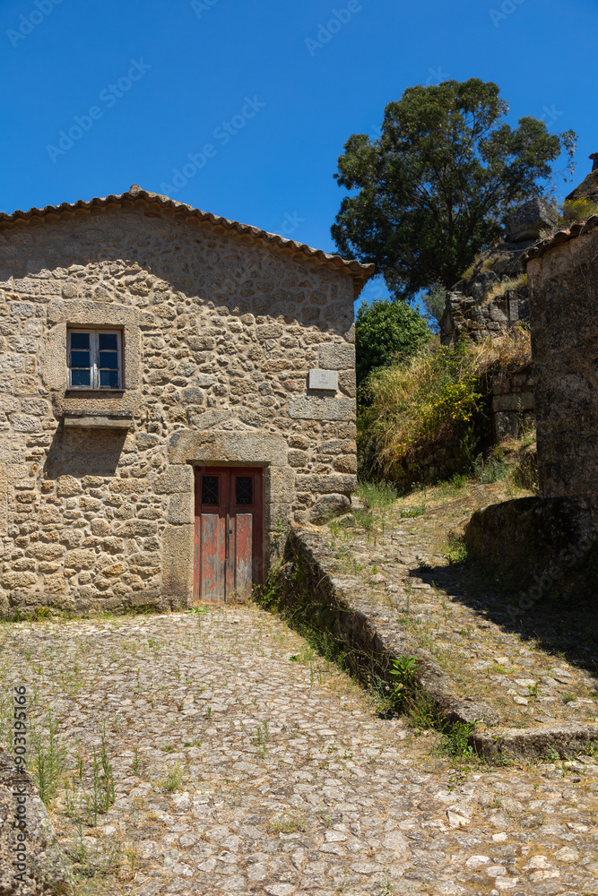 Charming stone house in the historic village of Monsanto, Portugal. The cobblestone streets and rustic architecture capture the timeless beauty and cultural heritage of this medieval town. Charming stone house in the historic village of Monsanto, Portugal. The cobblestone streets and rustic architecture capture the timeless beauty and cultural heritage of this medieval town.