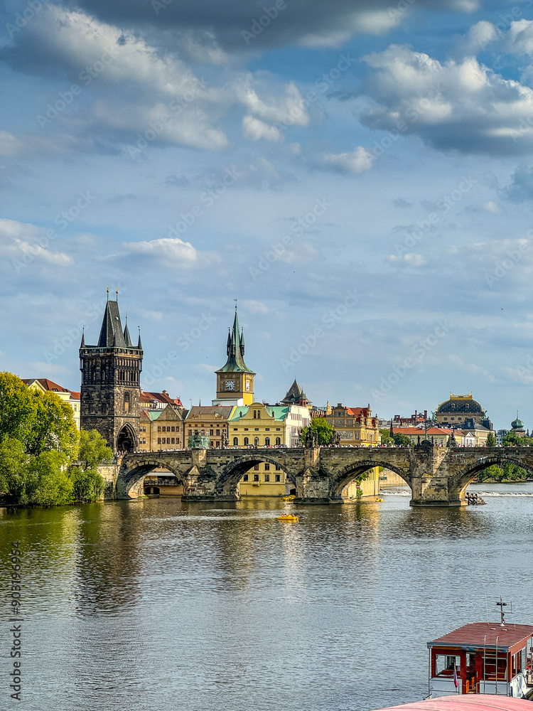 Charles Bridge and Old Town Tower in Prague, Czech Republic. Tourist boat tours on the Vltava river. Charles Bridge and Old Town Tower in Prague, Czech Republic. Tourist boat tours on the Vltava river.