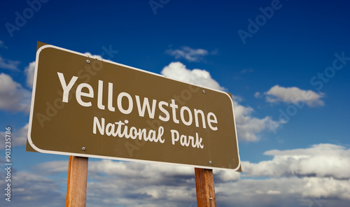 Yellowstone National Park (Wyoming, Montana, Idaho) Road Sign Against Blue Sky and Clouds.