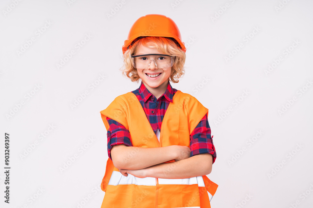 Busy caucasian little small preteen boy male child kid elementary primary middle school pupil teenager in builder`s uniform hardhat protective helmet isolated over white background Busy caucasian little small preteen boy male child kid elementary primary middle school pupil teenager in builder`s uniform hardhat protective helmet isolated over white background