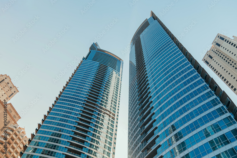 Modern skyscrapers and palm trees in urban city landscape Modern skyscrapers and palm trees in urban city landscape