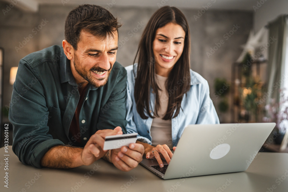 adult couple buy online on laptop with credit card at home adult couple buy online on laptop with credit card at home