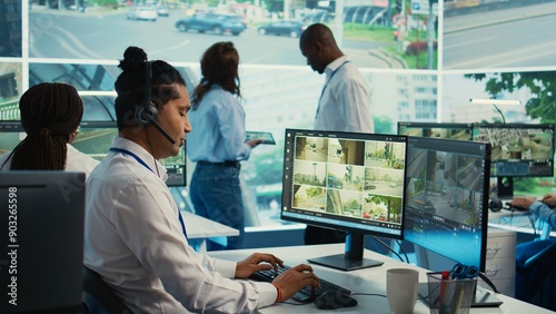 Indian call center operator gathers location and gps coordinates, monitoring traffic via surveillance camera system. Employee using CCTV real time footage to collect data. Camera B.