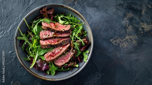 Modern Style Italian tagliata di manzo with dry aged sliced sirloin steak and lamb salad served as top view in a design ceramic bowl with copy space