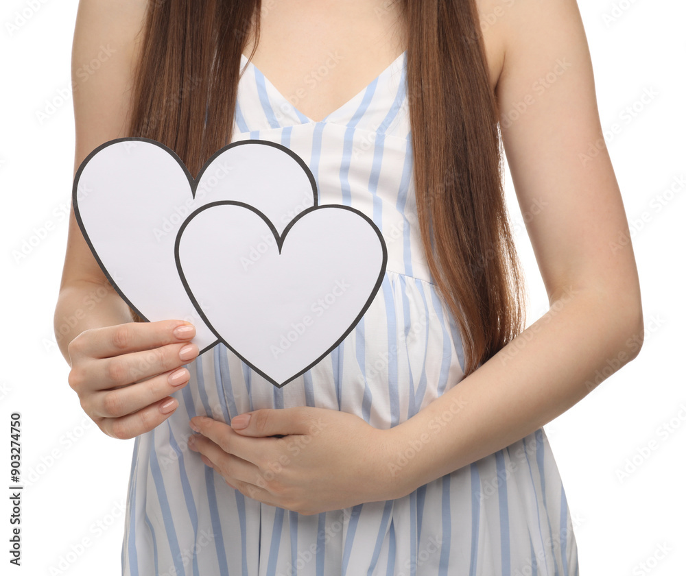 Expecting twins. Pregnant woman holding two paper cutouts of hearts on white background, closeup Expecting twins. Pregnant woman holding two paper cutouts of hearts on white background, closeup
