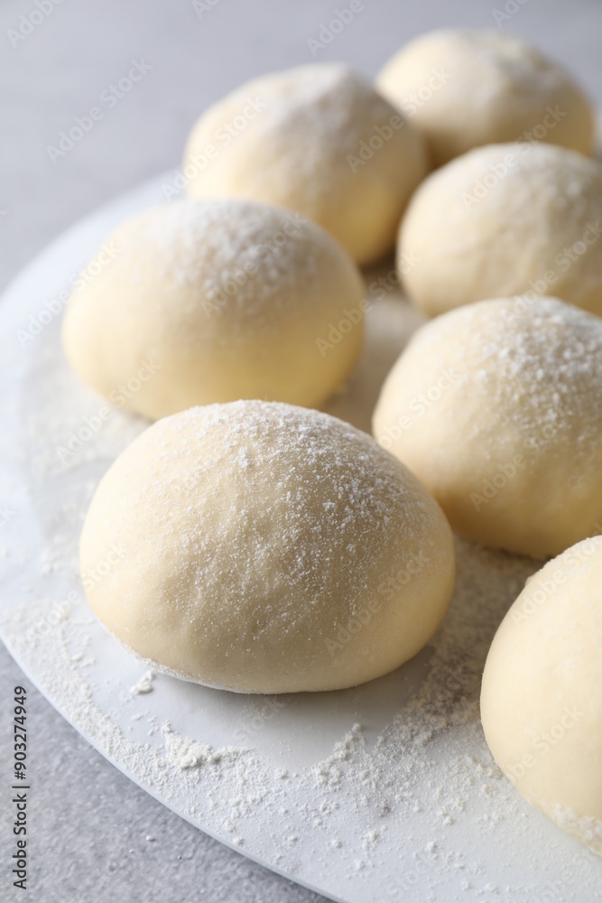 Raw dough balls on light grey table Raw dough balls on light grey table