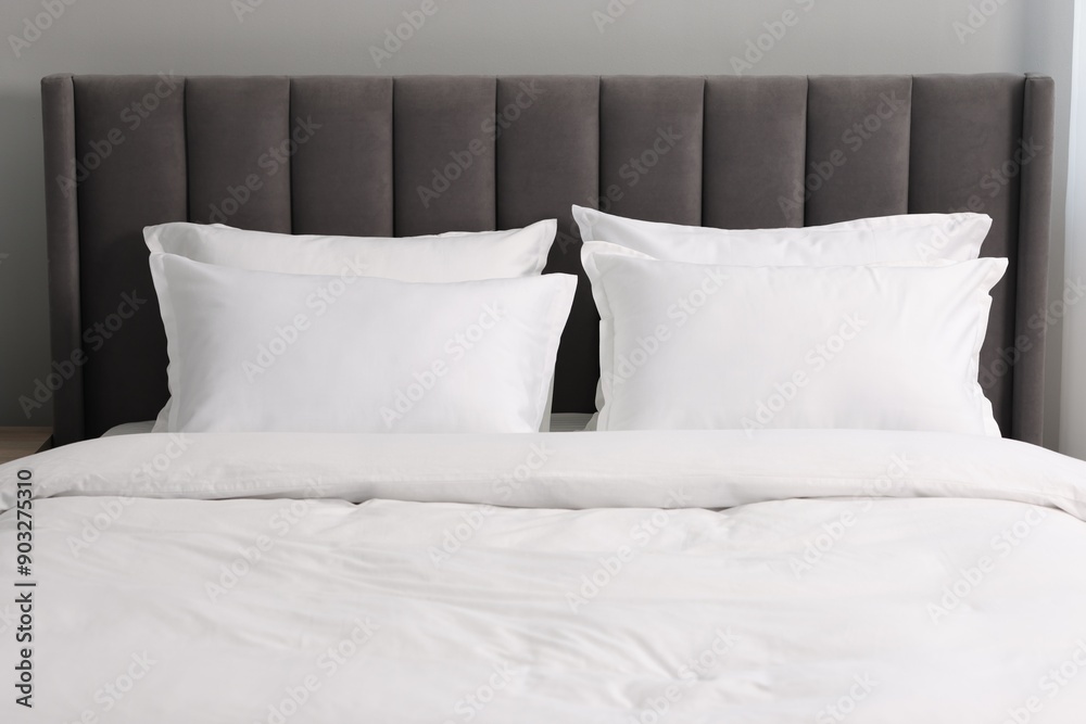 Many soft pillows on bed at home