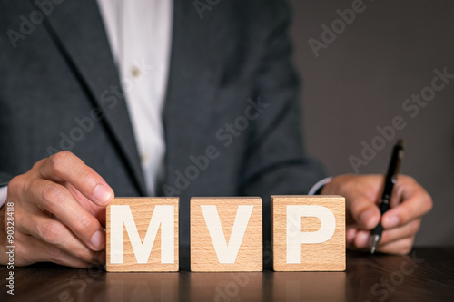 There is wood cube with the word MVP. It is an abbreviation for Minimum Viable Product as eye-catching image.