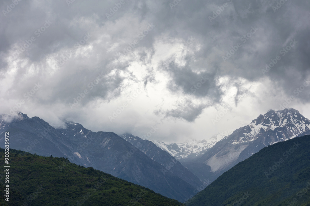 The snow-capped mountains are shrouded in clouds The snow-capped mountains are shrouded in clouds