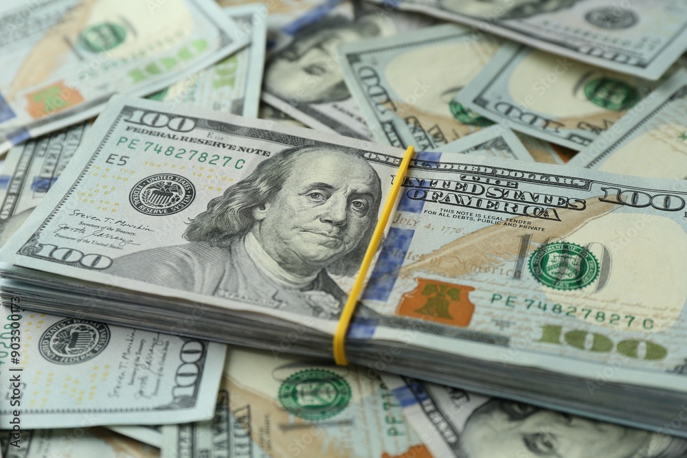 Many dollar banknotes as background, closeup view
