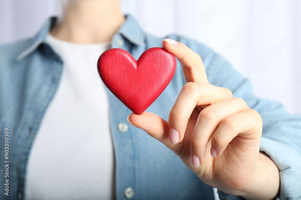 Woman holding red heart on light background, closeup Woman holding red heart on light background, closeup
