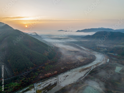 Aerial and sunrise view of fog and sea of clouds on Jujacheon Creek and mountains at Jucheon Ecological Park of Shinyang-ri near Jinan-gun, South Korea
 photo