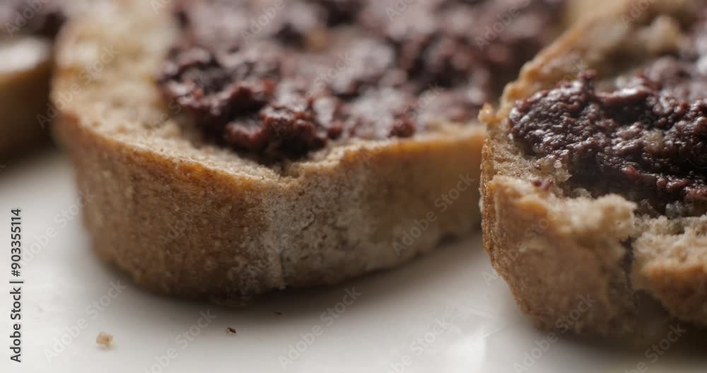 Tapenade olive puree on bread rotating close-up studio Tapenade olive puree on bread rotating close-up studio