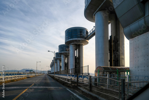 Gwongwan-ri, Pyeongtaek-si, Gyeonggi-do, South Korea - November 27, 2022: Afternoon view of road with concrete floodgate and dike on Asan Bay Embankment
 photo