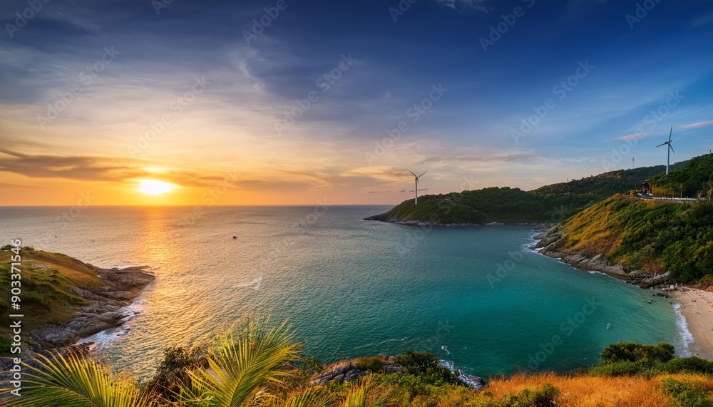 Fototapeta premium A breathtaking sunset over a secluded bay with wind turbines in the distance