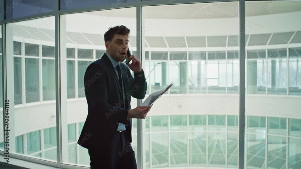 Irritated businessman calling cellphone complaining on mistake at corridor. Irritated businessman calling cellphone complaining on mistake at corridor.