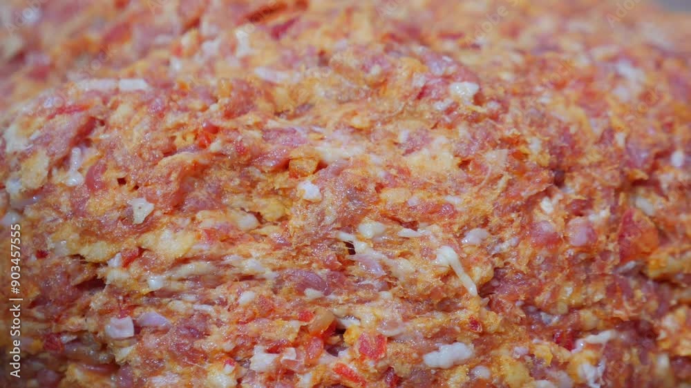 Hands are mixing ground meat in the kitchen as part of preparing a delicious dish Hands are mixing ground meat in the kitchen as part of preparing a delicious dish
