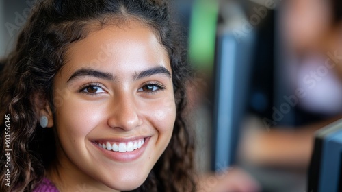 A smiling young girl at a computer, showcasing joy and engagement in a vibrant learning environment.