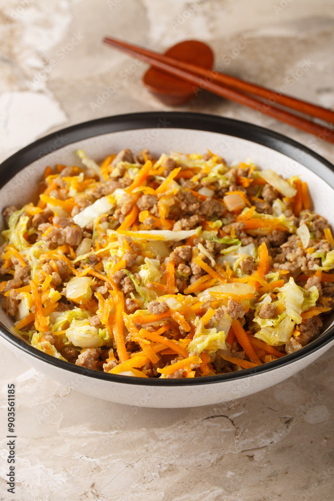 One Pot Egg Roll Bowl with beef, onion, carrot, cabbage closeup on the table. Vertical One Pot Egg Roll Bowl with beef, onion, carrot, cabbage closeup on the table. Vertical