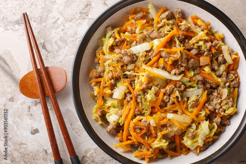 Obraz na płótnie Eggroll in a bowl with coleslaw mix and ground beef closeup on the table. Horizontal top view from above w salonie