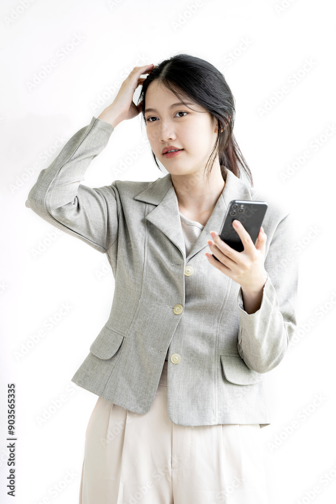 Portrait of confused asian woman holding mobile phone standing on white background. Portrait of confused asian woman holding mobile phone standing on white background.