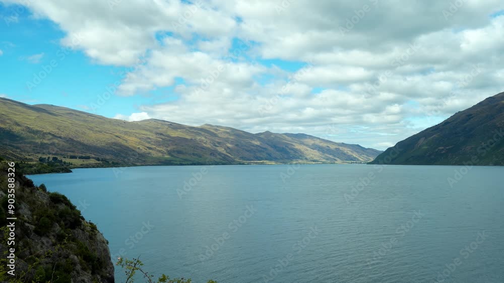 Lake Wakatipu viewed from Devil Staircase with cloud shadows passing over water and sloping valley Lake Wakatipu viewed from Devil Staircase with cloud shadows passing over water and sloping valley