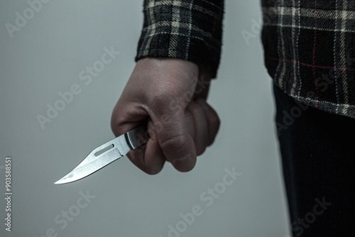 A man with a knife in his hand is the embodiment of a tense moment where crime photo