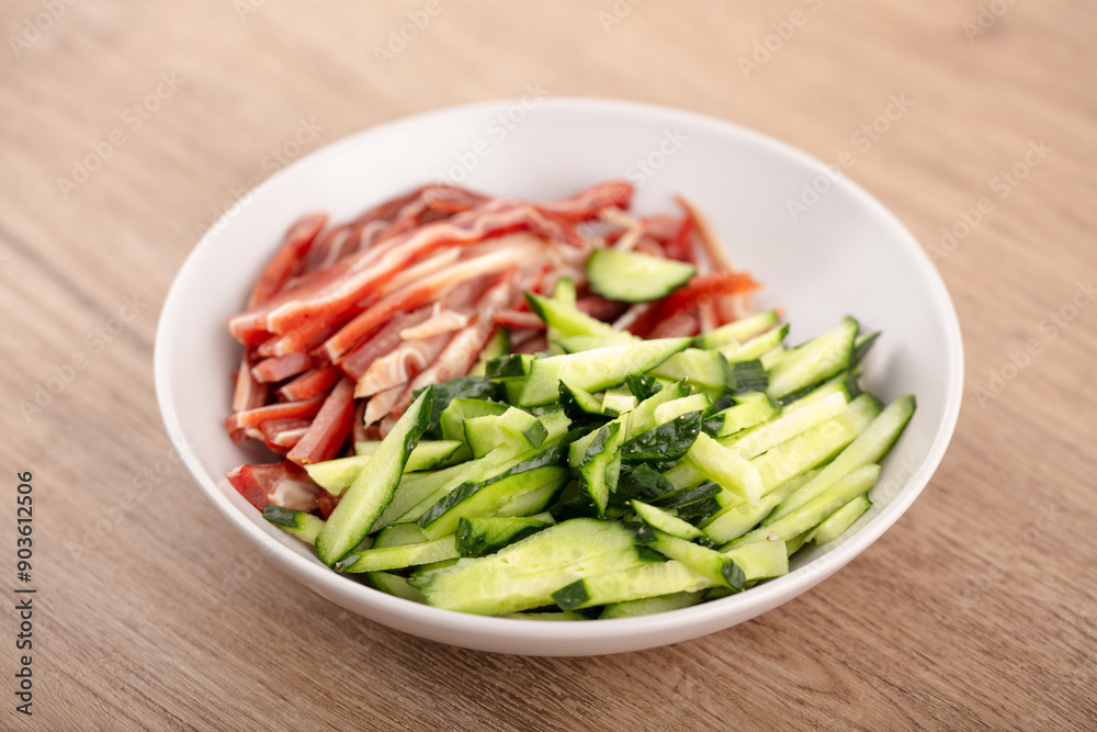 Sliced pig ears and cucumber shreds on the table Sliced pig ears and cucumber shreds on the table