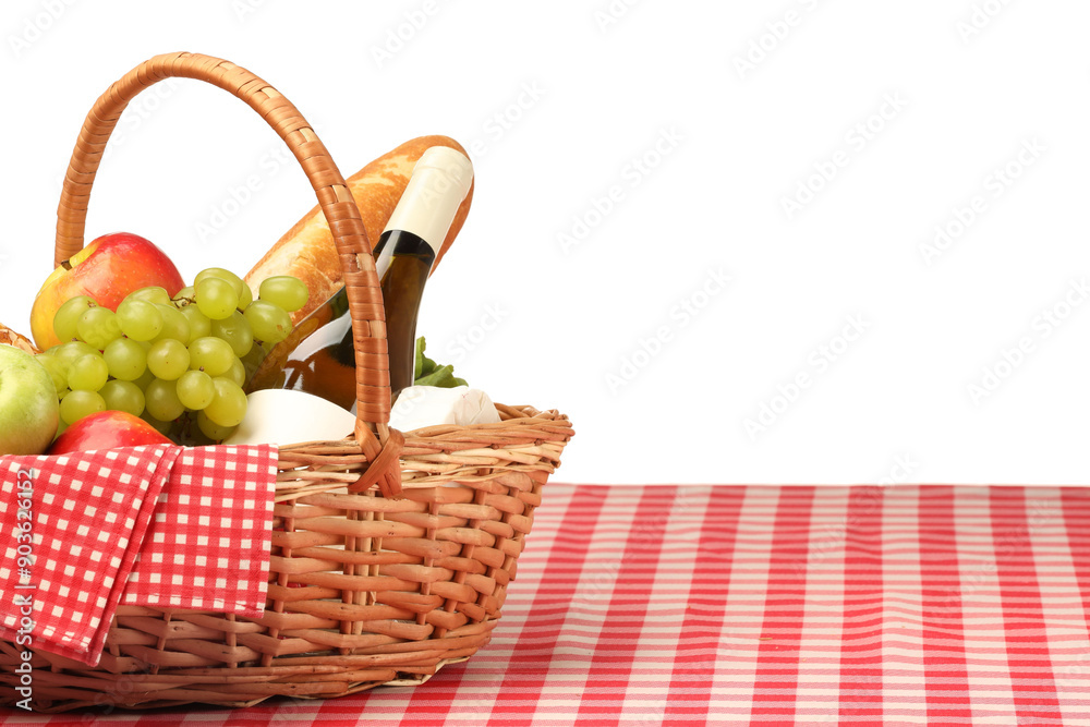 Picnic wicker basket with food, bottle of wine and napkin on table against white background. Space for text Picnic wicker basket with food, bottle of wine and napkin on table against white background. Space for text
