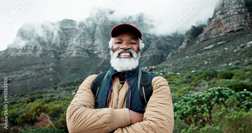 Portrait, mountain or black man hiking in nature adventure or journey in nature for outdoor travel. Senior, crossed arms and happy hiker on trail for holiday, retirement or trekking to explore France