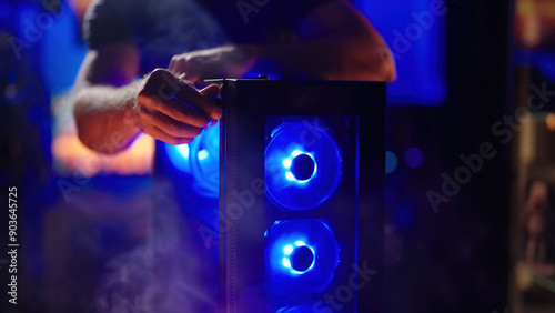 Person assembling smoking hot gaming RGB computer glass panel