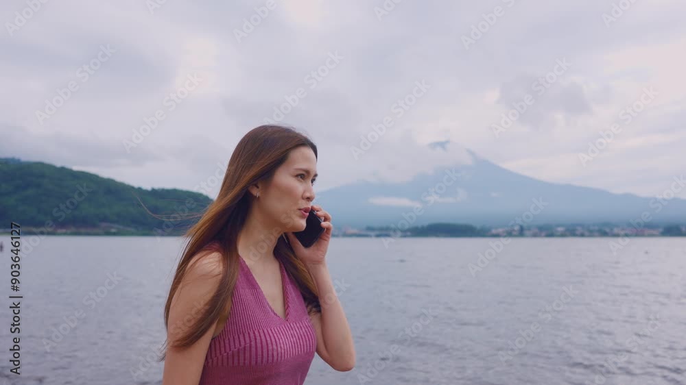 Asian beautiful woman traveler talking on phone while walk at mountain. Asian beautiful woman traveler talking on phone while walk at mountain.