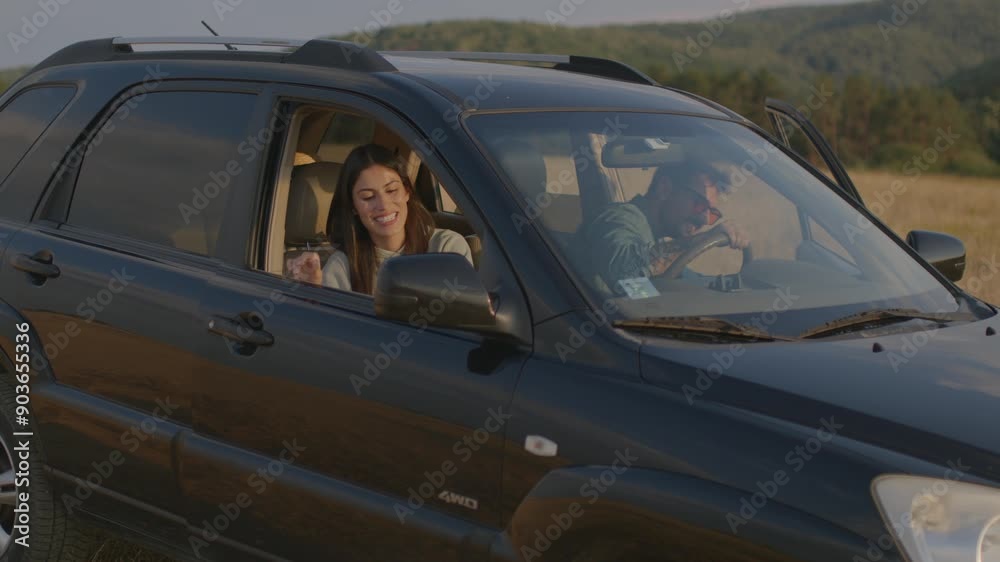 Loving couple in the car arrived at the destination, getting out of the car Loving couple in the car arrived at the destination, getting out of the car