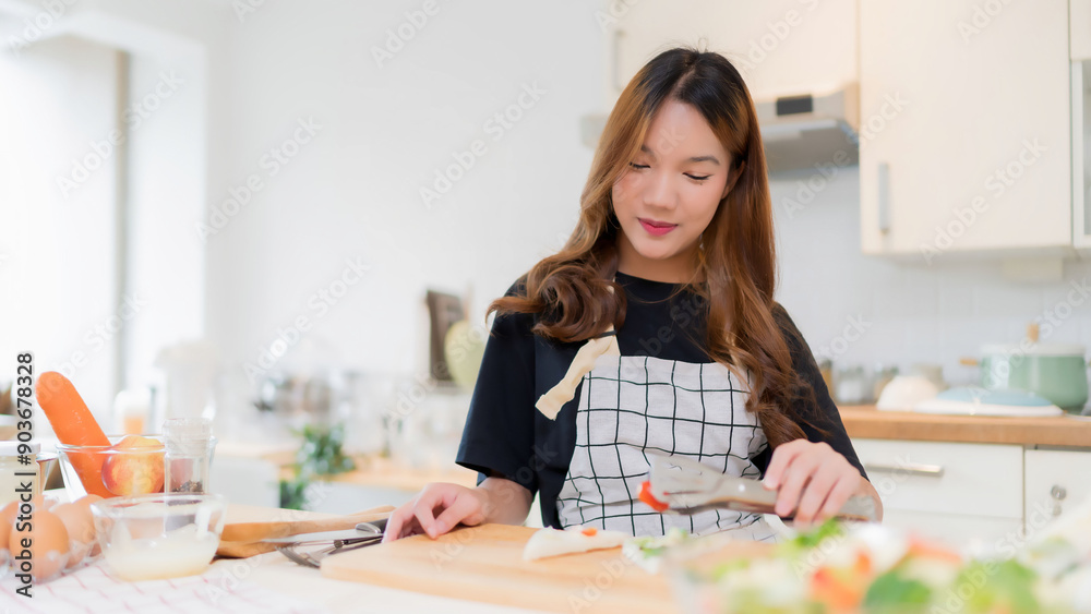 Young asian woman using tongs to cooking delicious sandwich and fresh vegetables salad for healthy breakfast food to preparing homemade snack in modern kitchen with healthy lifestyle at home Young asian woman using tongs to cooking delicious sandwich and fresh vegetables salad for healthy breakfast food to preparing homemade snack in modern kitchen with healthy lifestyle at home