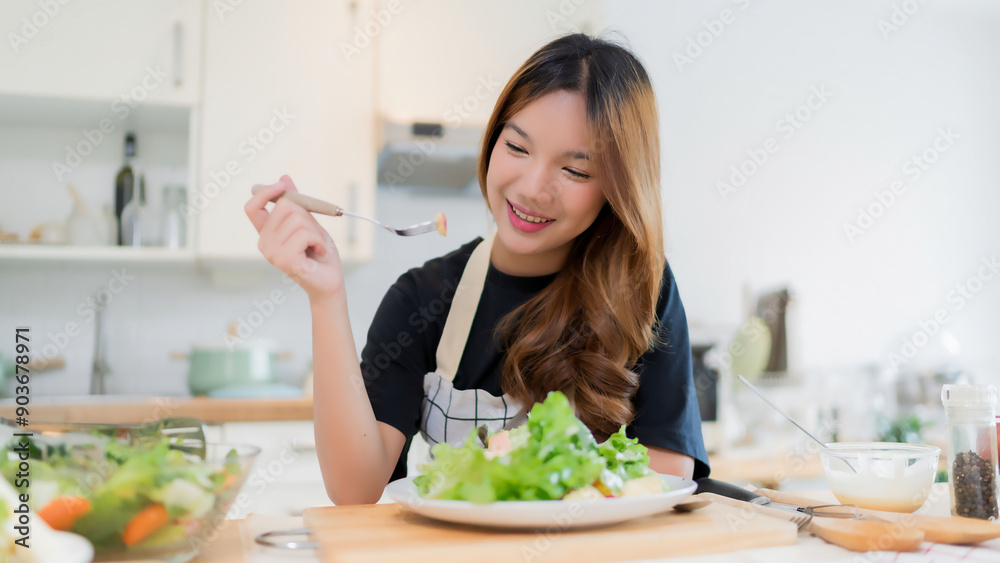 Young asian woman eating apple in vegetables salad with happiness after mixing fresh vegetables salad with dressing and cooking healthy breakfast food in modern kitchen with healthy lifestyle at home Young asian woman eating apple in vegetables salad with happiness after mixing fresh vegetables salad with dressing and cooking healthy breakfast food in modern kitchen with healthy lifestyle at home