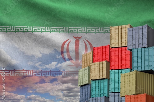 Iran flag and big stack of shipping cargo containers in docks with sky background close up photo