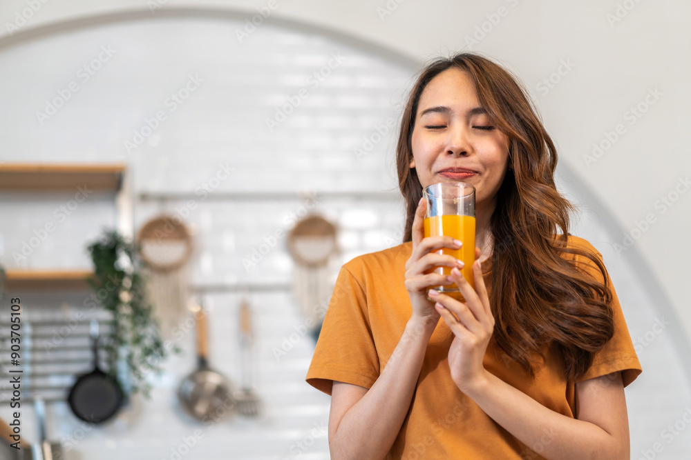 Portrait of beauty body slim healthy asian woman drinking glass of juice and orange.young girl preparing cooking healthy drink with fresh orange juice in kitchen at home.Diet concept.healthy drink Portrait of beauty body slim healthy asian woman drinking glass of juice and orange.young girl preparing cooking healthy drink with fresh orange juice in kitchen at home.Diet concept.healthy drink