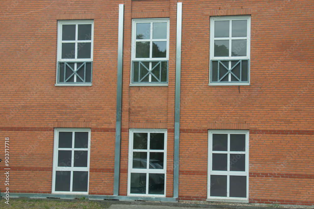 Modern beautiful white frame window on a brick wall of a house Modern beautiful white frame window on a brick wall of a house