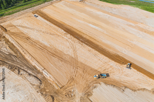 Construction vehicles leveling dirt area