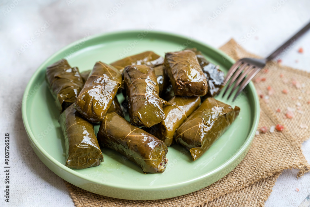 Delicious dolmades , grape leaves stuffed with rice .Greek cuisine Delicious dolmades , grape leaves stuffed with rice .Greek cuisine