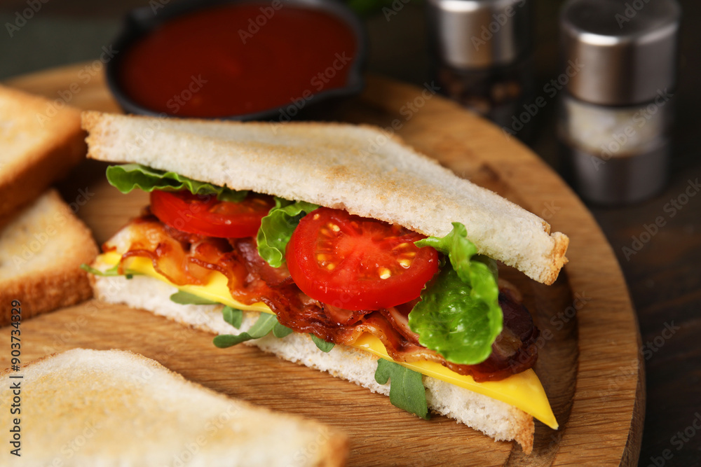 Delicious sandwich with fried bacon on wooden board, closeup Delicious sandwich with fried bacon on wooden board, closeup