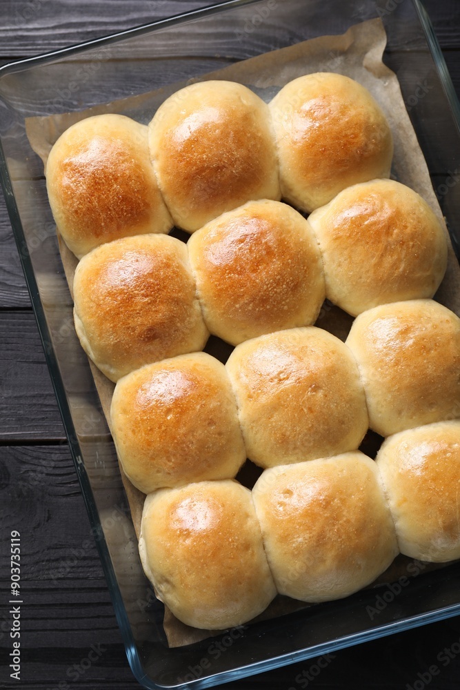 Delicious dough balls in baking dish on black wooden table, top view Delicious dough balls in baking dish on black wooden table, top view