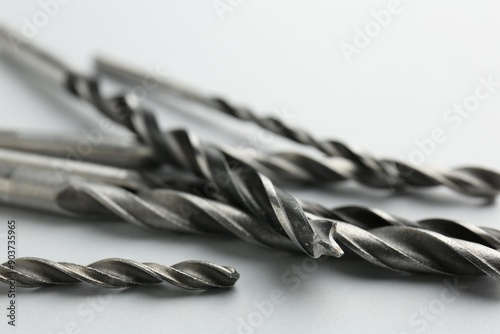 Cuadro en lienzo Many different drill bits on light grey background, closeup