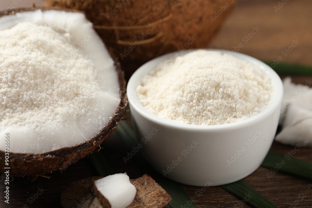 Coconut flour in bowl and fresh fruits on wooden table, closeup Coconut flour in bowl and fresh fruits on wooden table, closeup