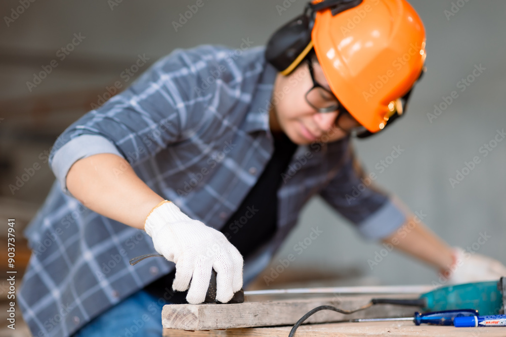 Carpenter asian man working with equipment on wooden table at under construction home or carpentry shop. Carpenter asian man working with equipment on wooden table at under construction home or carpentry shop.
