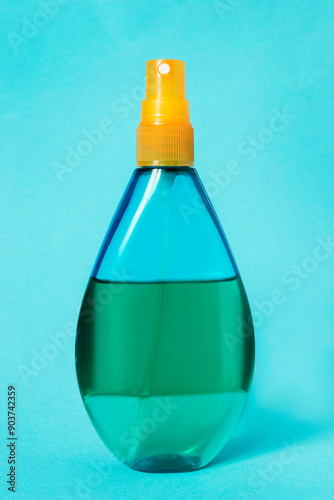 Spraying oil on blue background photo