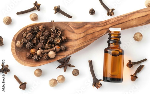 Natural Clove Oil with Cloves on Wooden Spoon photo