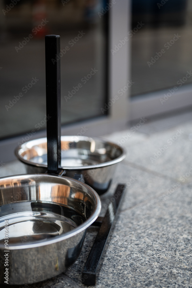 bowl of drinking water for dogs in public facilities - caring for animals in cities