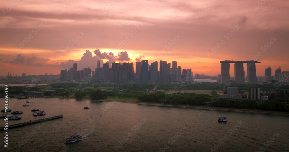 Iconic Marina Bay Sands hotel and Singapore skyline backlit by vibrant sunset Iconic Marina Bay Sands hotel and Singapore skyline backlit by vibrant sunset